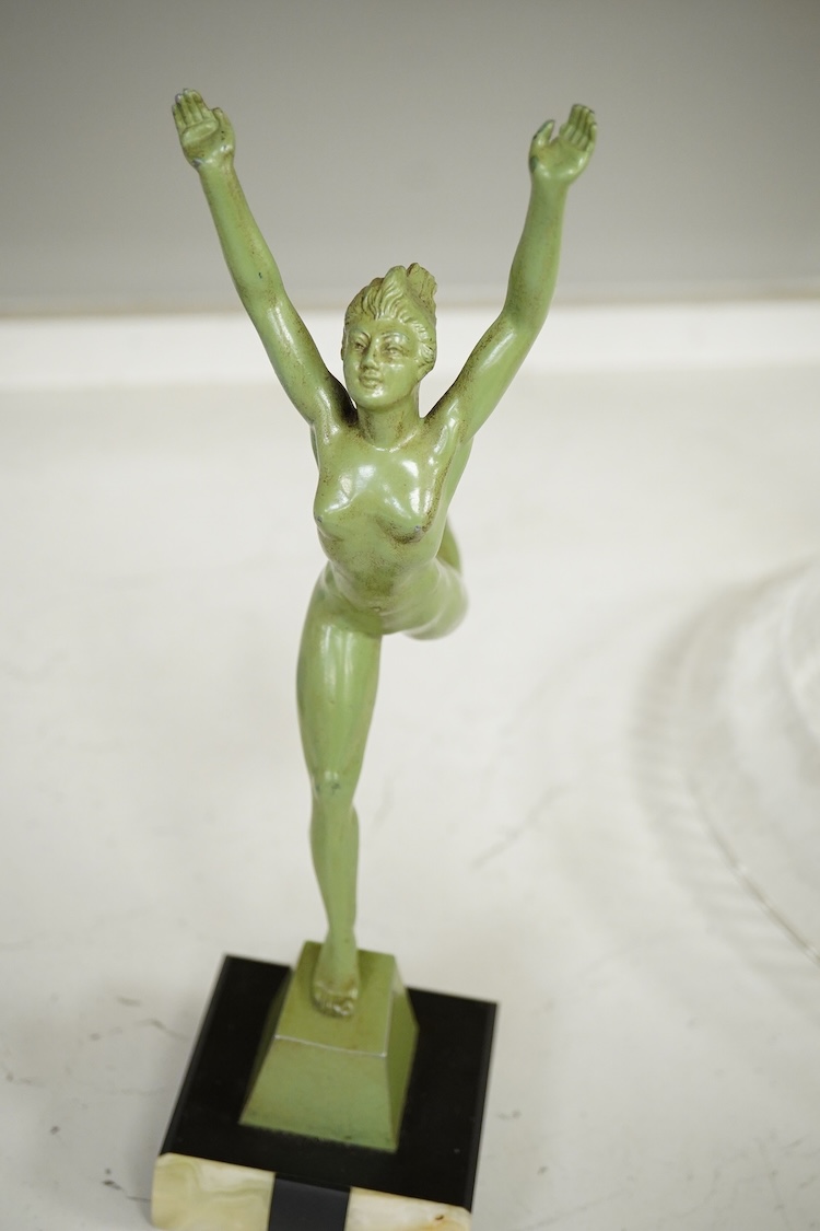An Art Deco patinated spelter figurine of a nude dancer raised on black and green onyx base, 29cm high